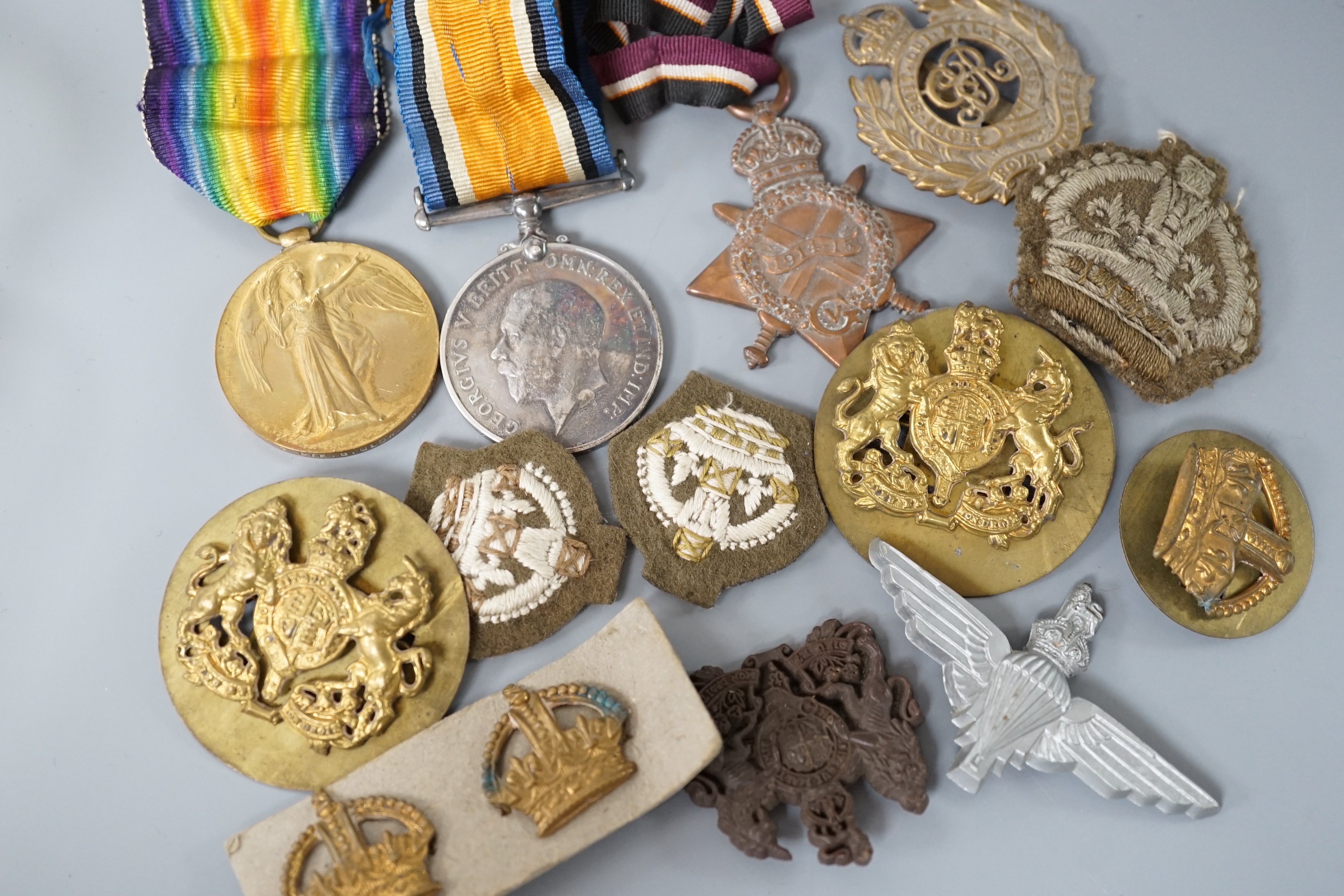 Two WWI medals, collection of cap badges and buttons, Queen Mary tobacco tin and a 66th Infantry Brigade concert party clickety clack cigarette case etc